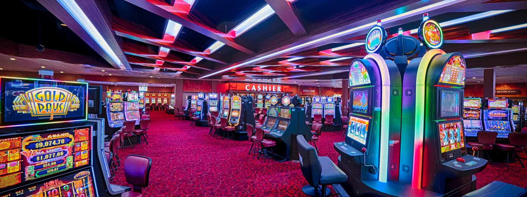 A brightly colored casino with dozens of game machines